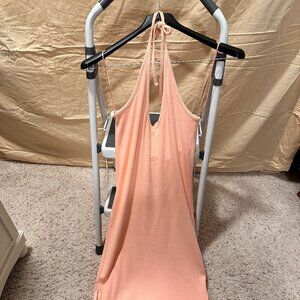 Orange midi dress, straps for shoulders to be tied back around neck, open legs